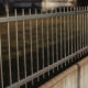 A black metal fencing around the park